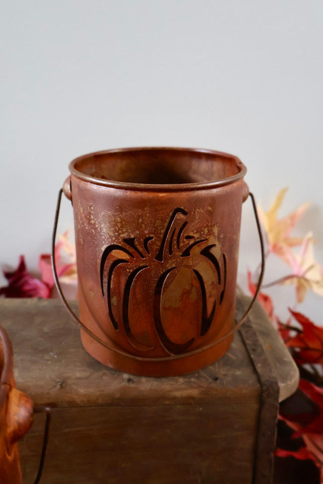 Rust-colored pumpkin-shaped bucket with a textured surface.