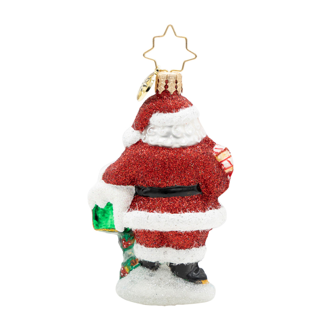 Glittery Santa Claus ornament holding a green mailbox, seen from the back.