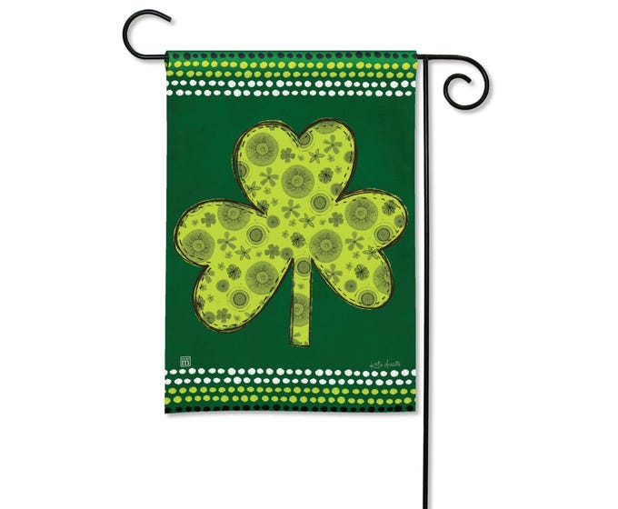 Green garden flag with a large, light green shamrock pattern and dotted borders.
