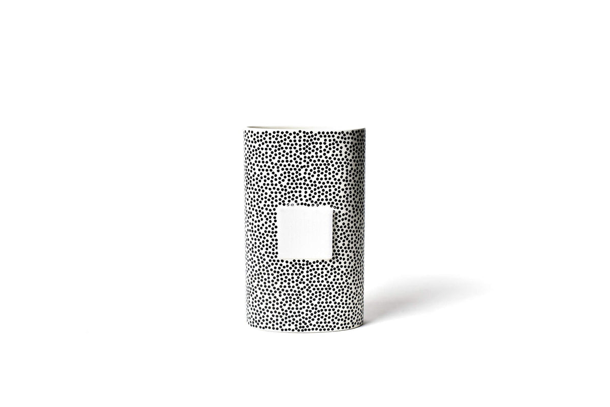 Ceramic vase with black small dots on a big oval shape