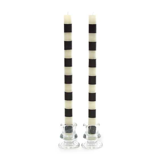 Set of two 12-inch tall dinner candles with horizontal black and white bands in glass holders.