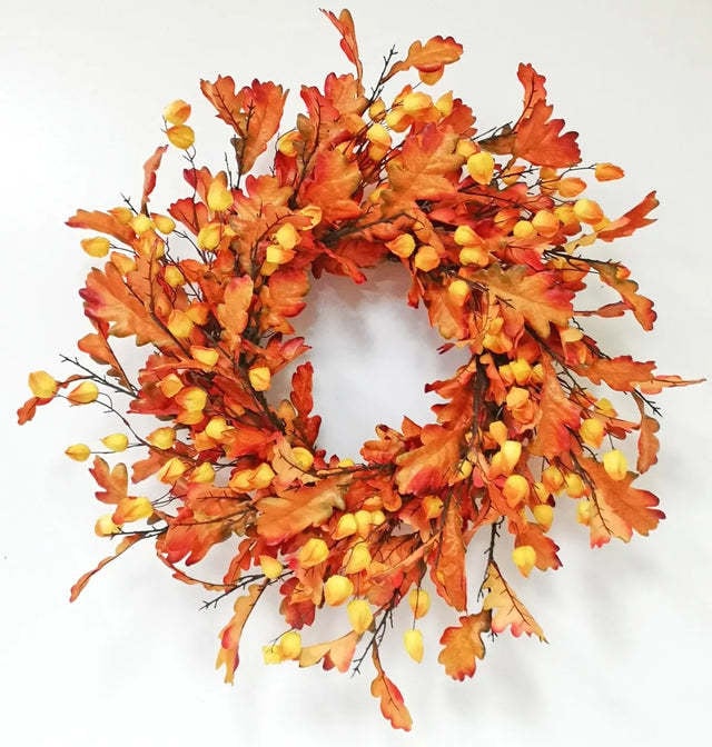 Oak leaf wreath with a central lantern accent in warm brown tones.