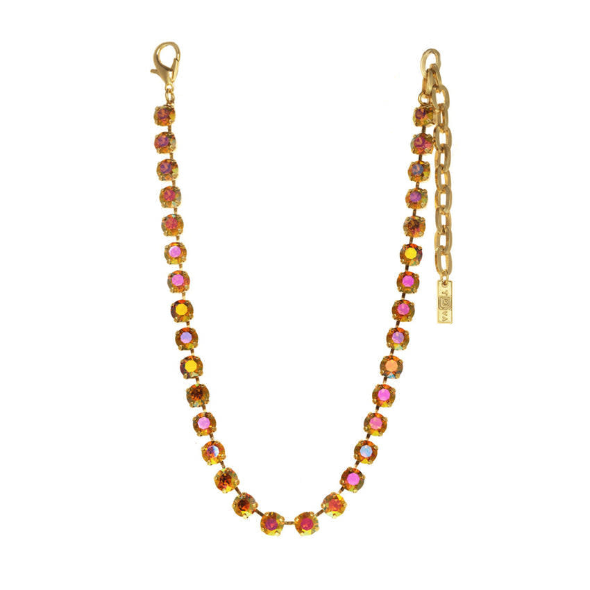 Antique gold Oakland necklace with watermelon-colored crystals on a brass base