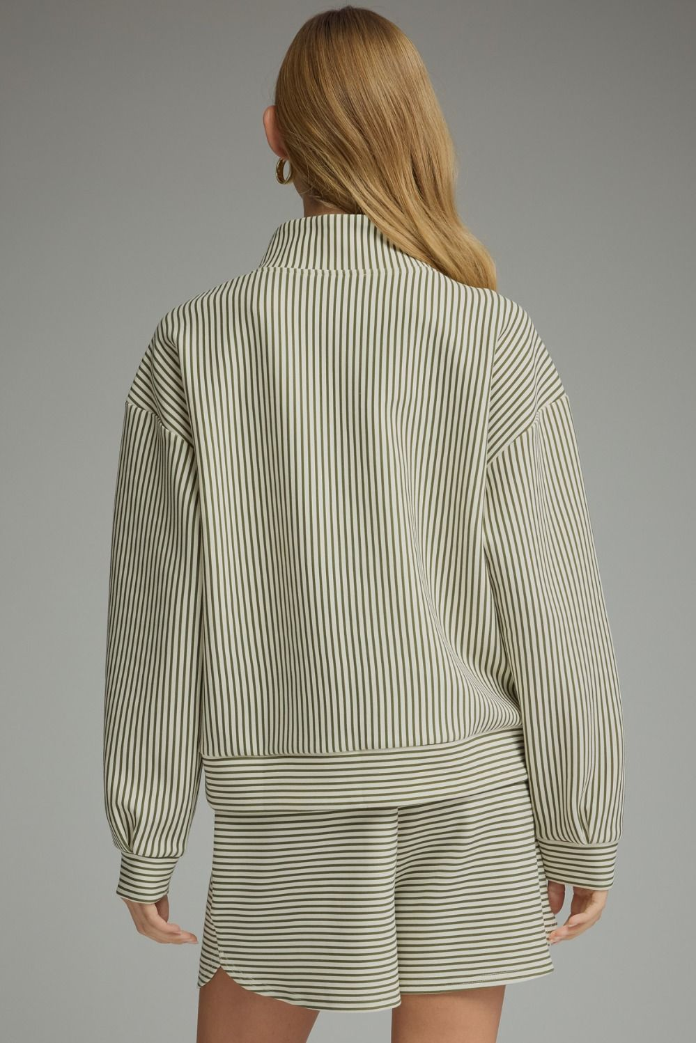 Back view of a woman wearing the Melissa olive and white stripe long sleeve knit top and shorts.