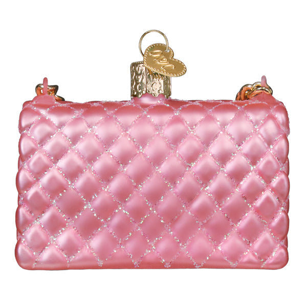 Pink quilted purse glass Christmas ornament with glitter accents and a gold heart charm.
