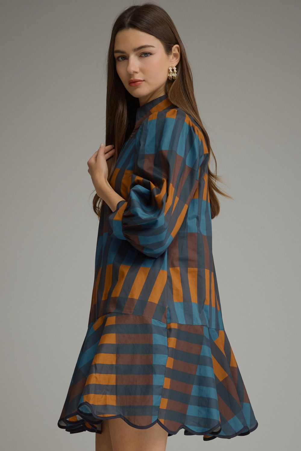 Woman wearing the Harper Plaid ¾ Balloon Sleeve Mini Dress in a blue and orange checkered pattern.