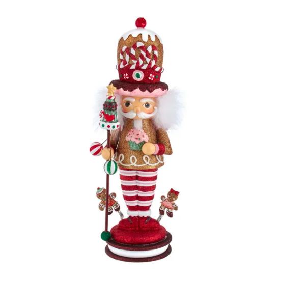 Wood composite Gingerbread King Nutcracker with peppermint hat, striped pants, and gingerbread figures on base.