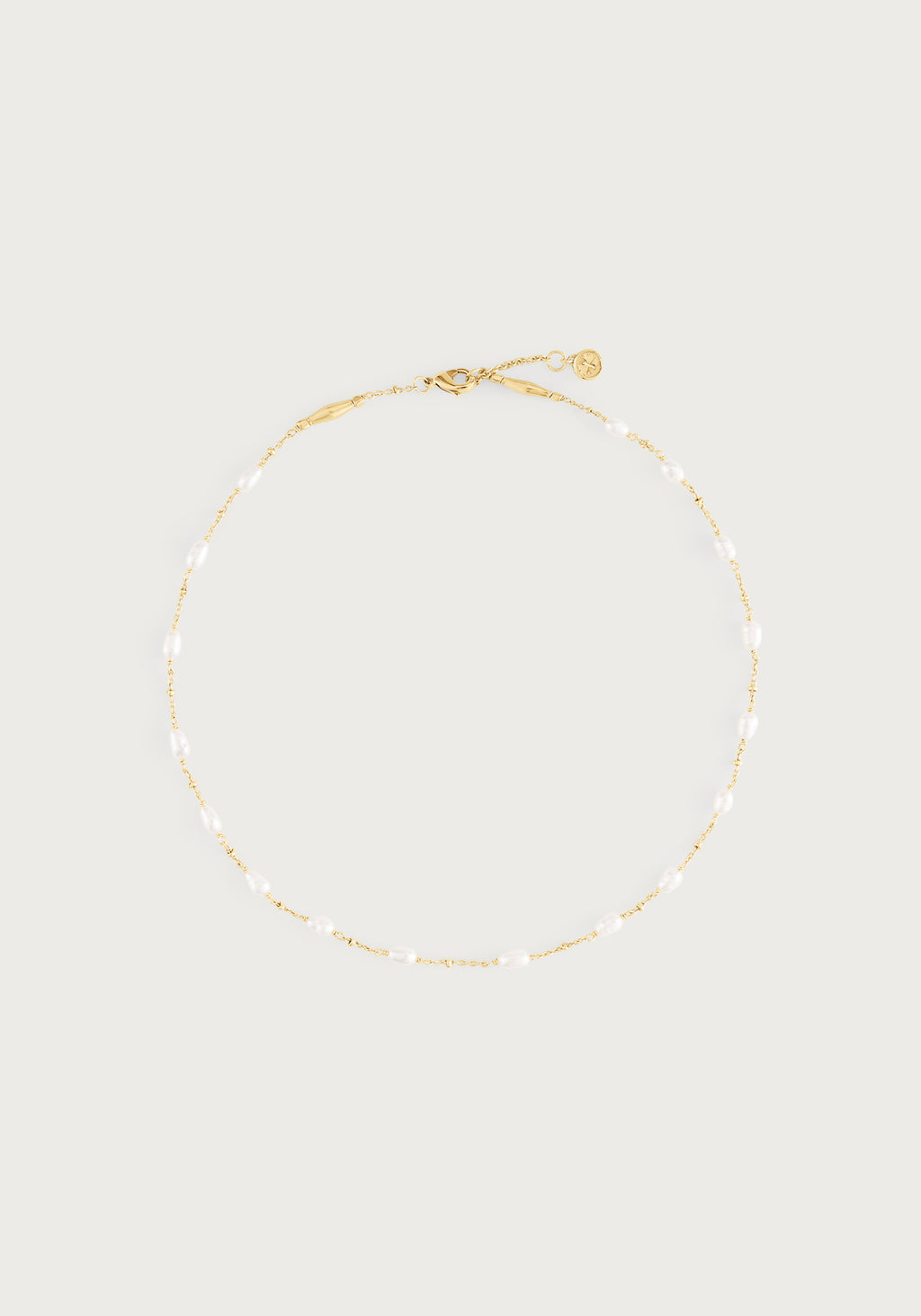 Milos Multi Beaded Necklace featuring a gold chain with small white freshwater pearls.