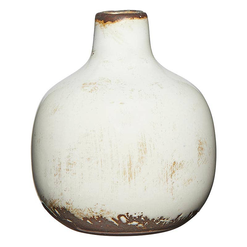 Small ceramic vase with a simple cylindrical shape in neutral tone.