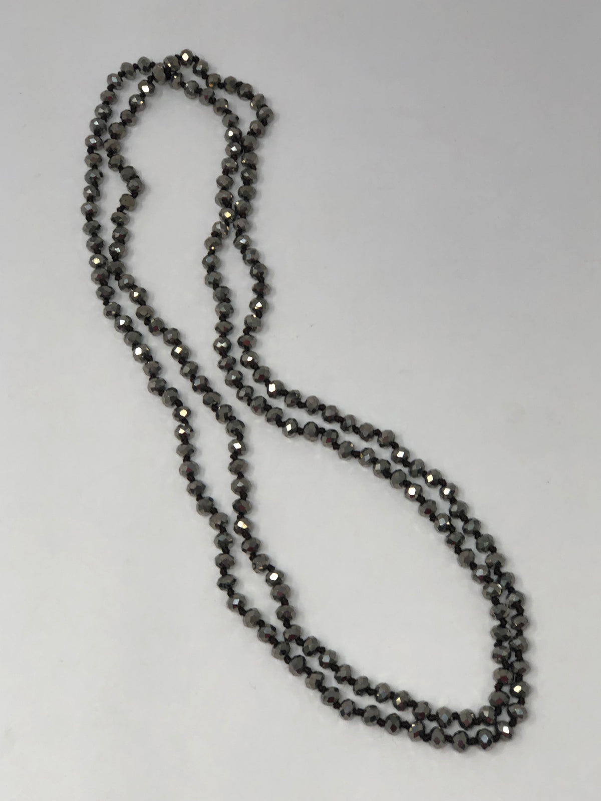 60-inch dark brown crystal beaded necklace with knotting between beads and no clasp