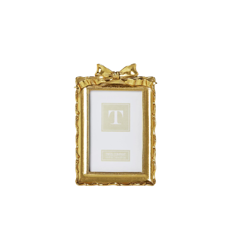 Vintage gold resin picture frame with an ornate scalloped edge and a decorative bow on top.