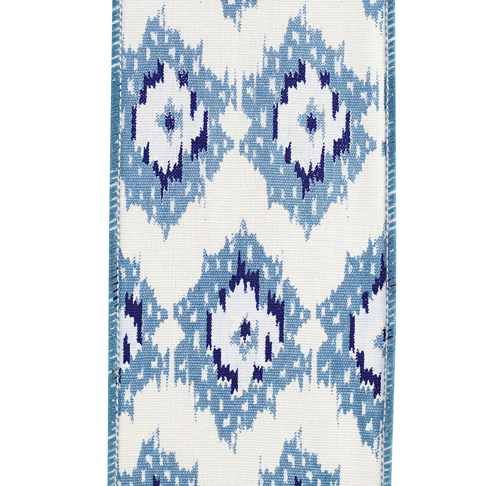 4 inch wide white canvas ribbon with blue ikat diamond pattern and wired edges.