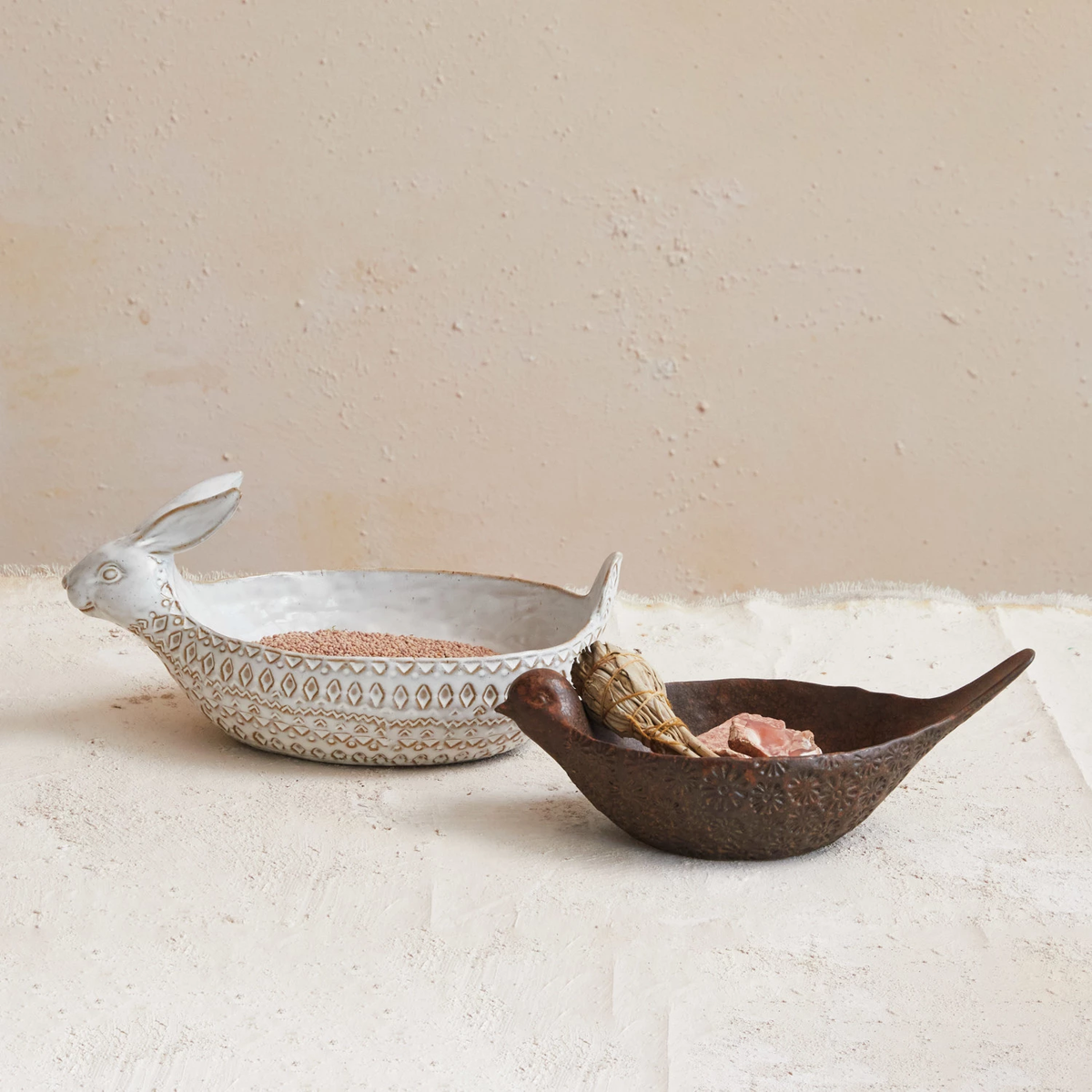 Stoneware rabbit bowl with reactive glaze finish in natural color featuring a debossed silhouette.
