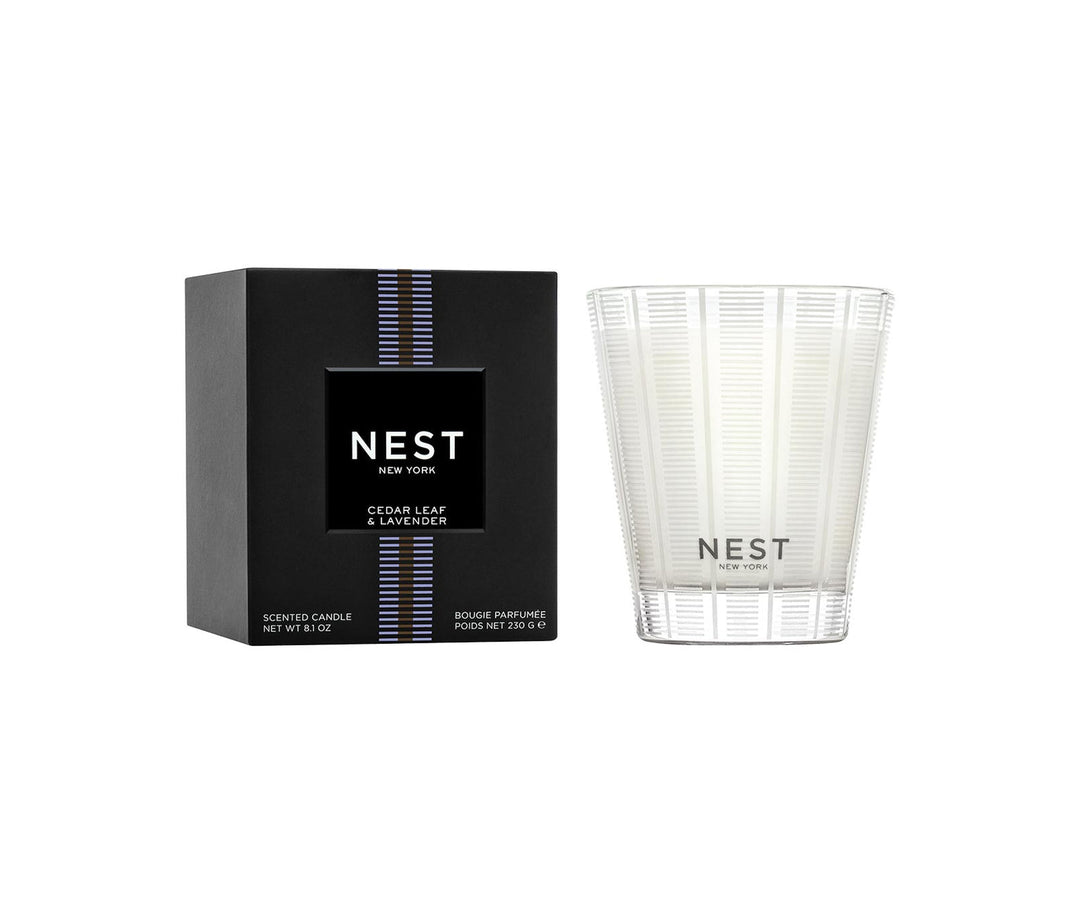 Nest Cedar Leaf & Lavender Classic Candle in a frosted glass vessel next to its black box.
