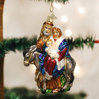 Flight to Egypt Ornament featuring a gold desert scene with figures on horseback against an orange and blue sky.
