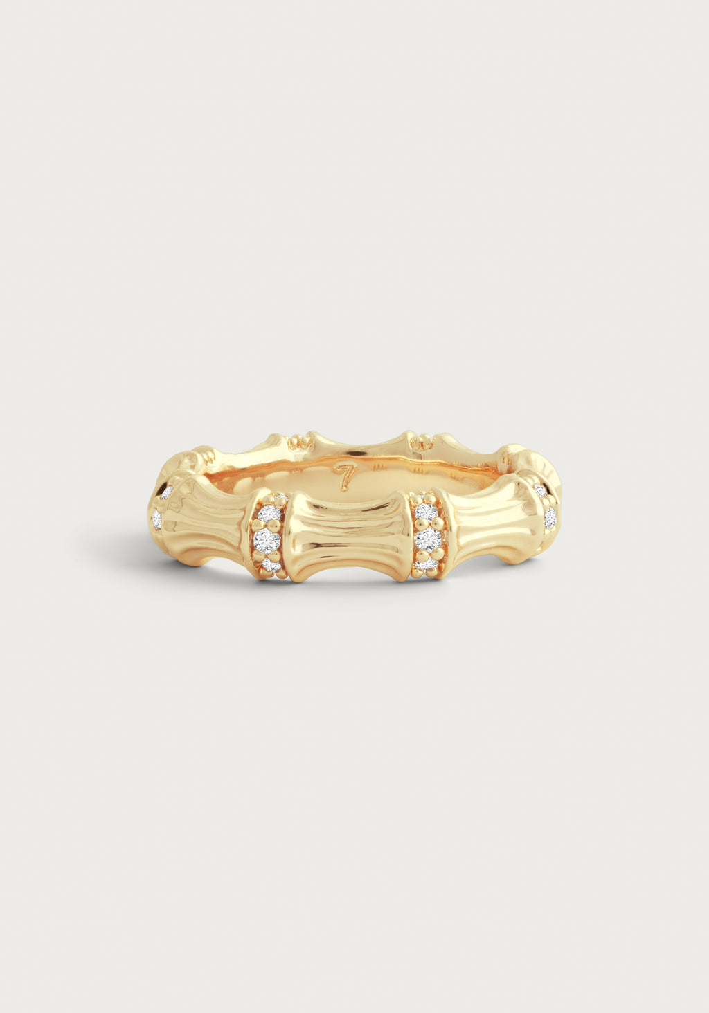 Gold-plated bamboo-style ring with crystal pavé accents on a white background.