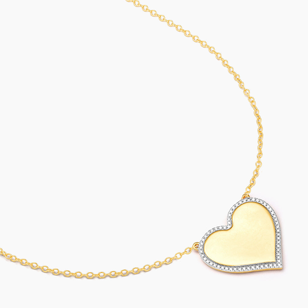 Sterling silver pendant necklace with a heart-shaped diamond accent on an adjustable chain.