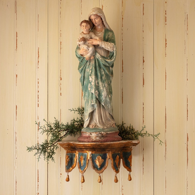 Chapelle Etagere wall shelf with gold and blue details, holding a religious statue.
