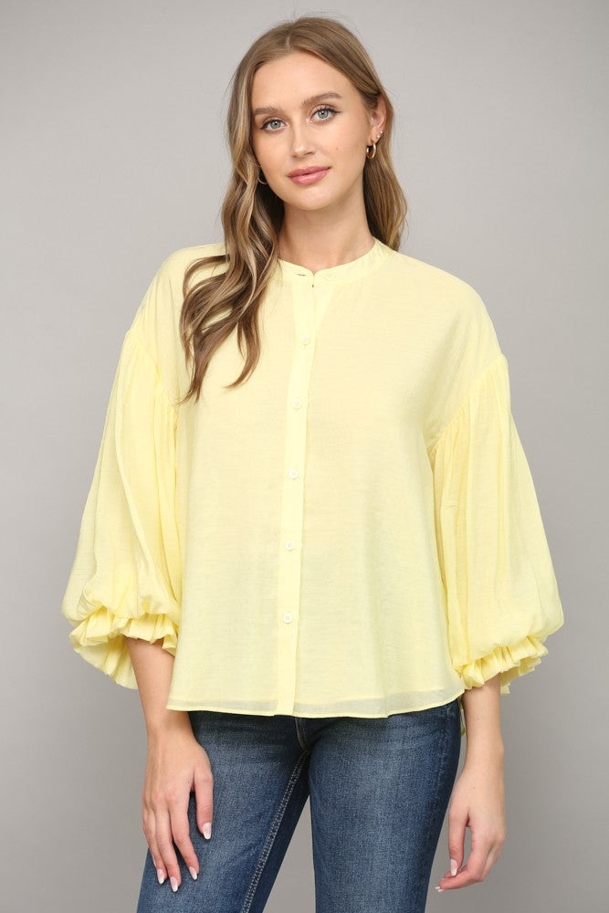 Diana button-down shirt in navy rayon-nylon blend featuring puff sleeves.