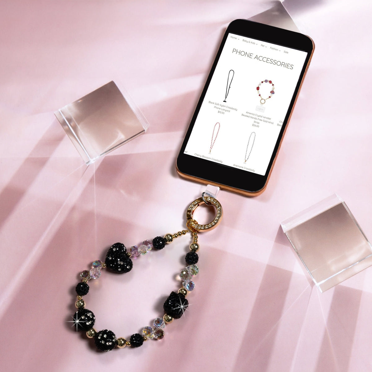 Black crystal beaded wristlet phone strap with gold gemmed clasp and iridescent beads.