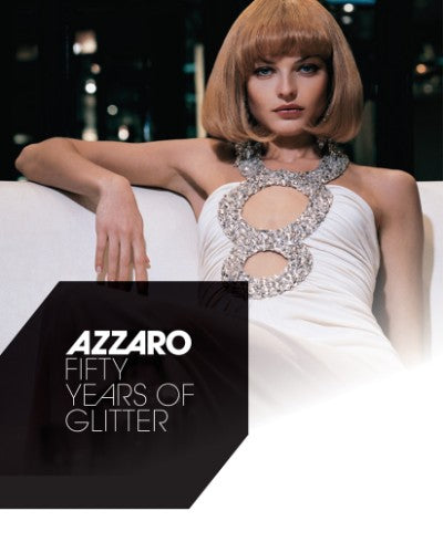Azzaro Fifty Years of Glitter perfume bottle with glittery gold cap on black background