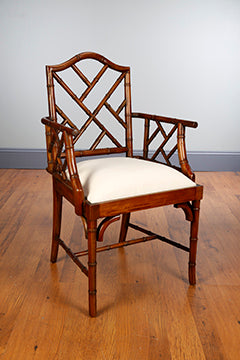 Walnut finish bamboo arm chair with a classic curved silhouette