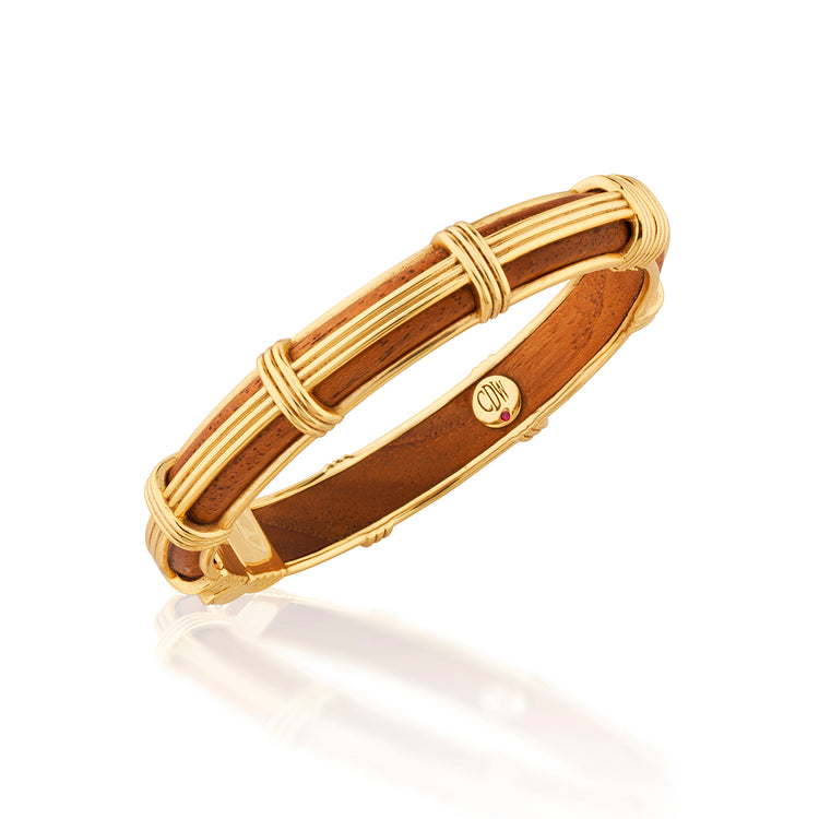 Gaia Petite Hinged Bangle in gold-tone metal with a teak wood inlay and ribbed corded accents.