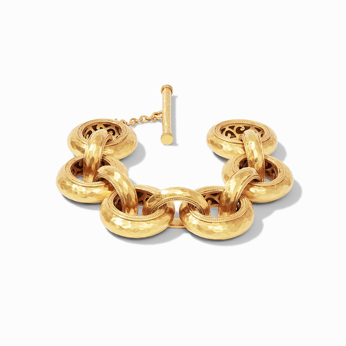 Gold link bracelet with hammered texture and pierced interior detail