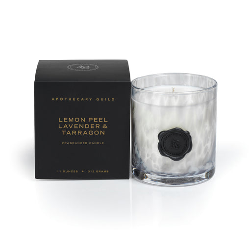 Apothecary Guild Lemon Peel, Lavender & Tarragon candle in an opal glass jar next to its black box.