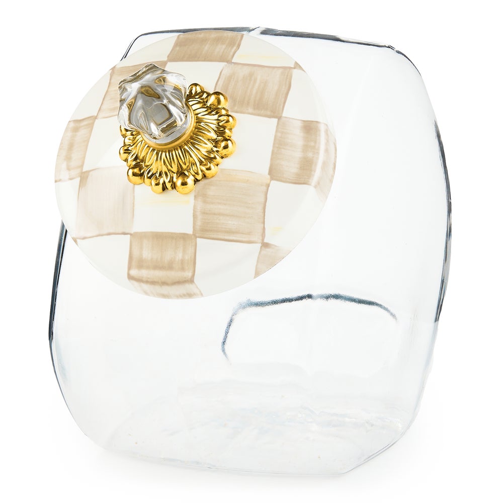 Glass cookie jar with hand-glazed steel lid featuring a painted mocha check pattern and brass knob.