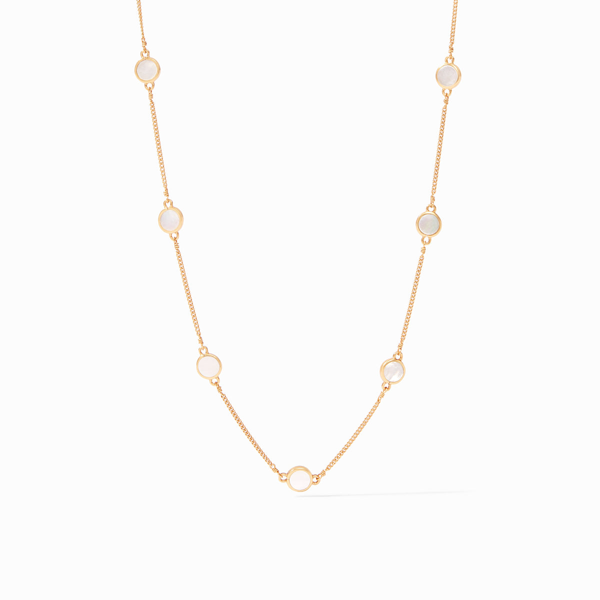 Valencia gold station necklace with delicate chain and circular mother of pearl insets.