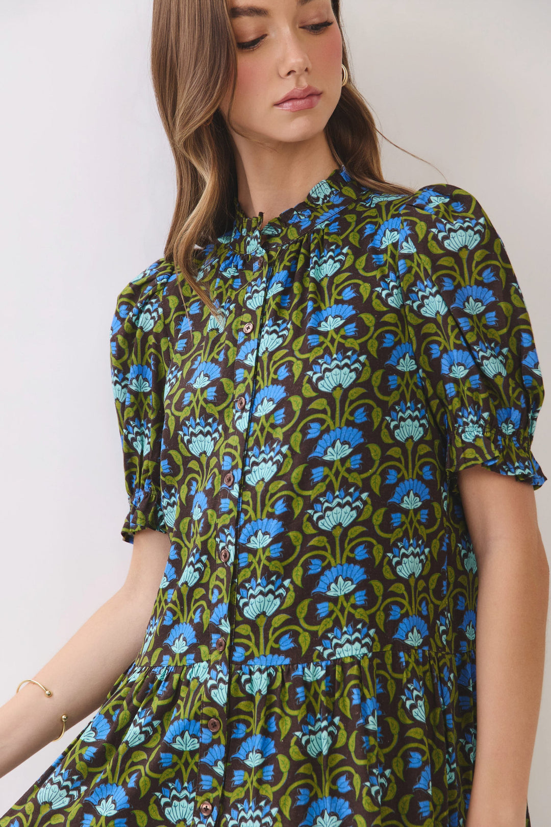 Penelope floral print mini dress with puff sleeves, ruffle neckline, and button front bodice.