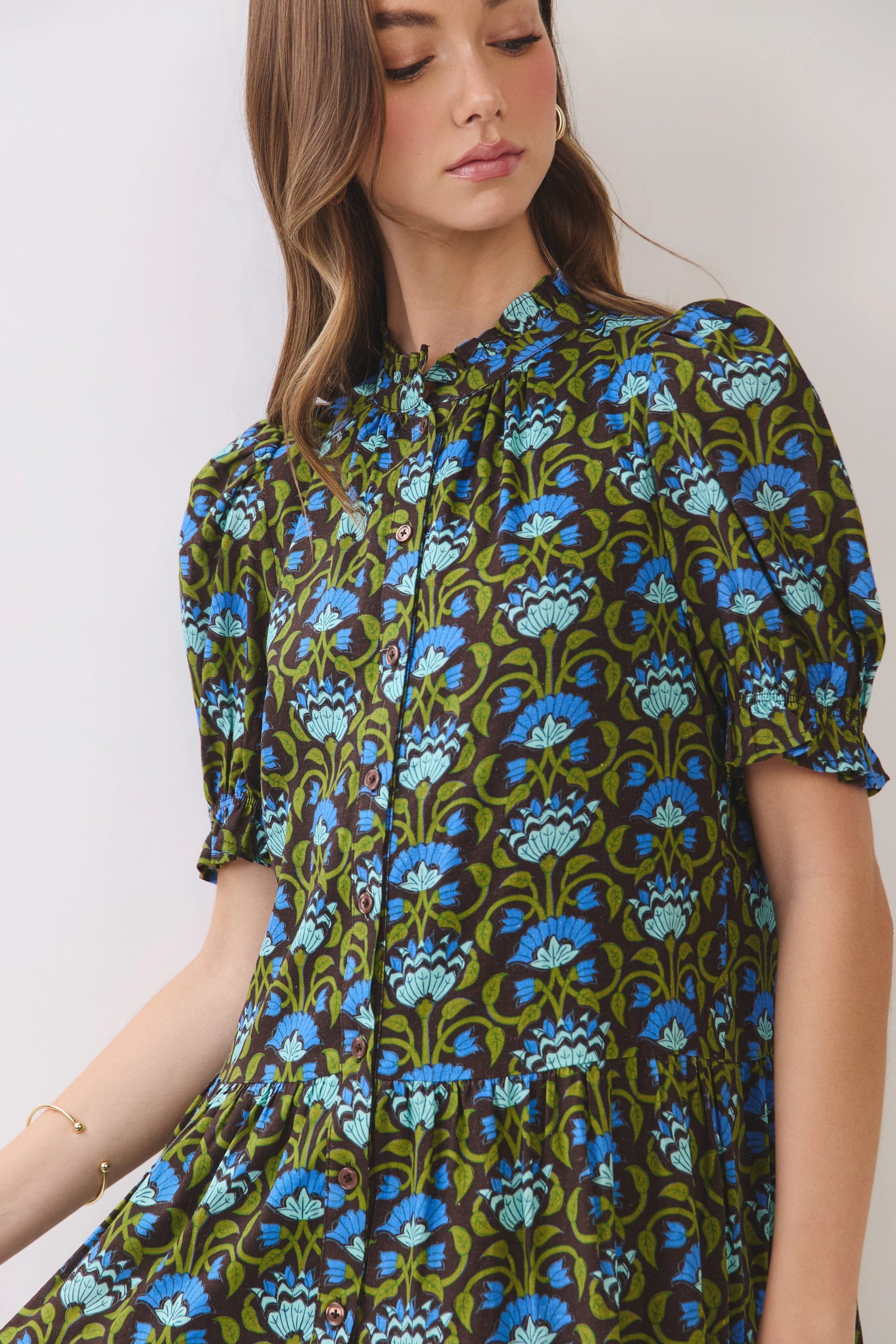 Penelope floral print mini dress with puff sleeves, ruffle neckline, and button front bodice.
