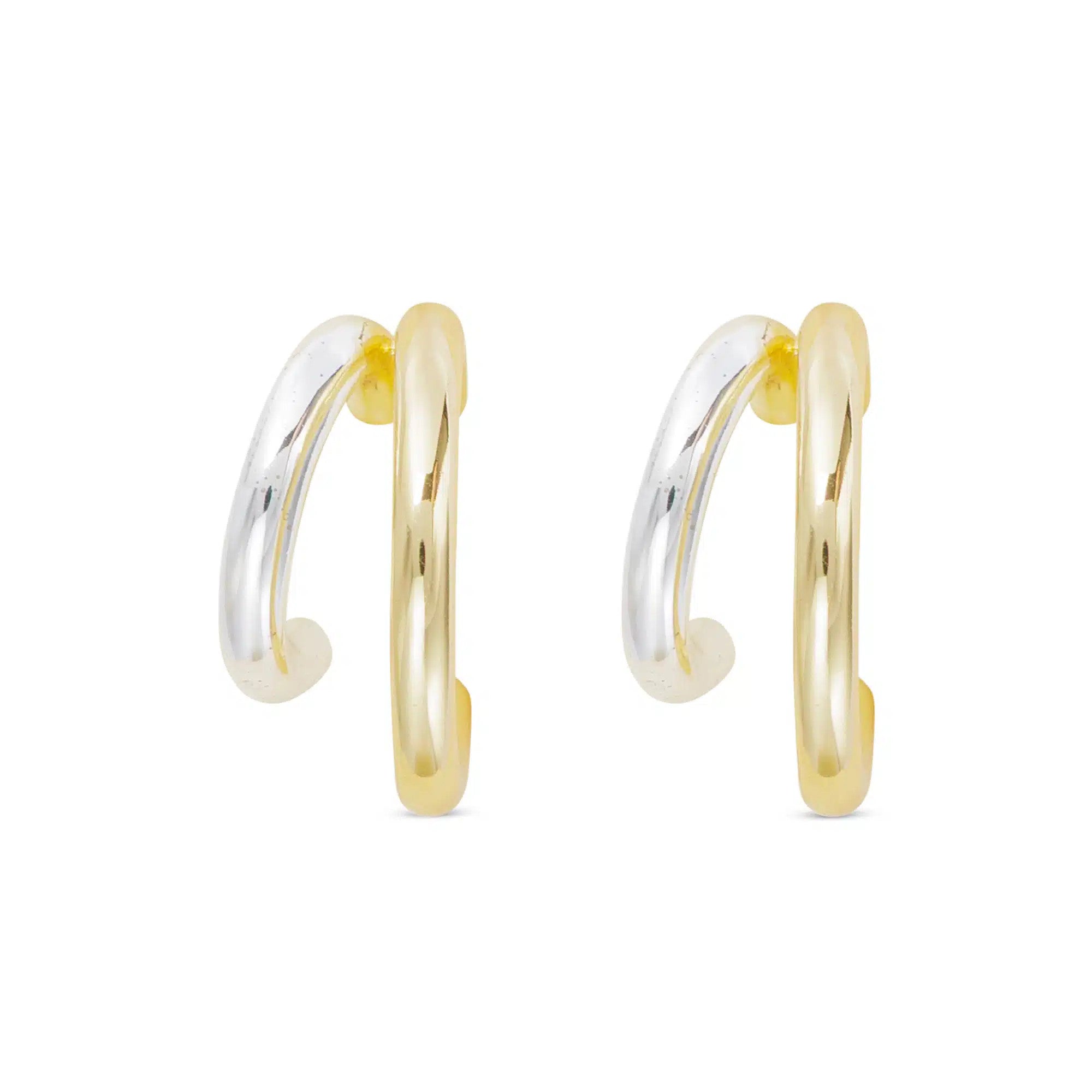 A pair of polished double hoop earrings featuring one gold and one silver hoop on each earring.