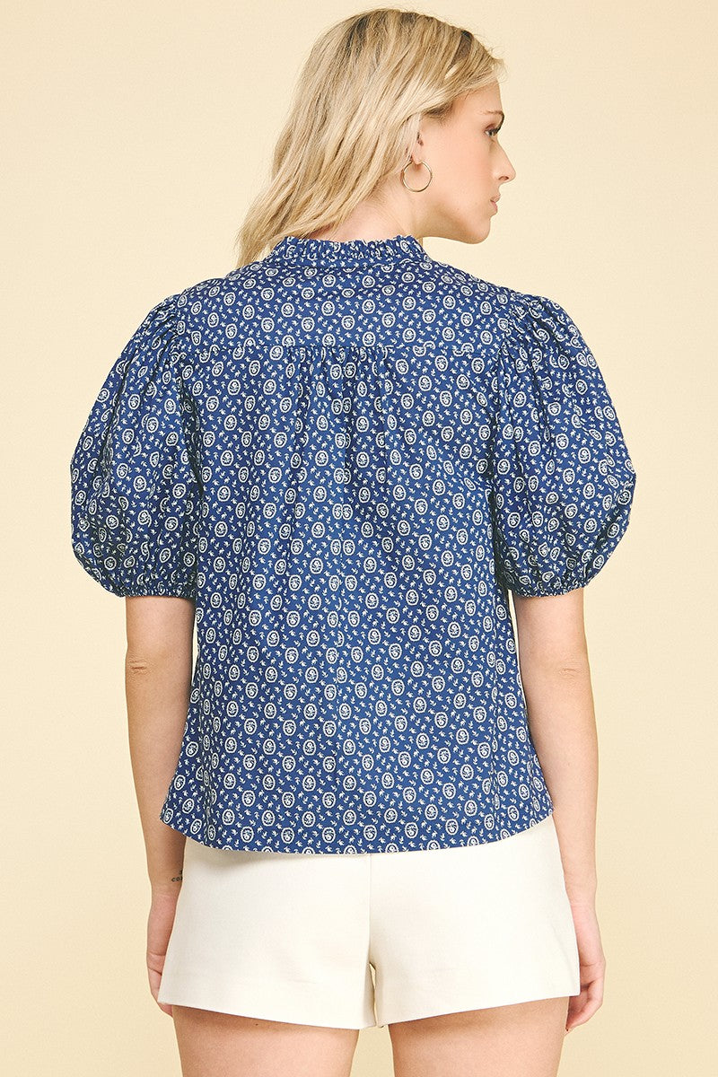 Megan floral print cotton blouse with ruffled V-neck, balloon sleeves, elastic cuffs, and a relaxed silhouette.