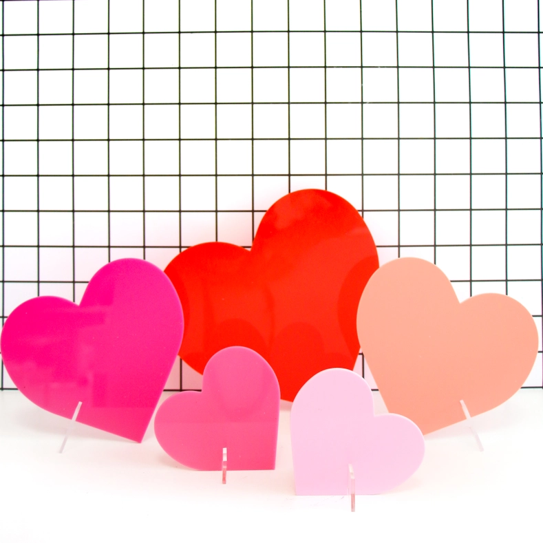 Pink acrylic heart conversation piece measuring four to eight inches tall.