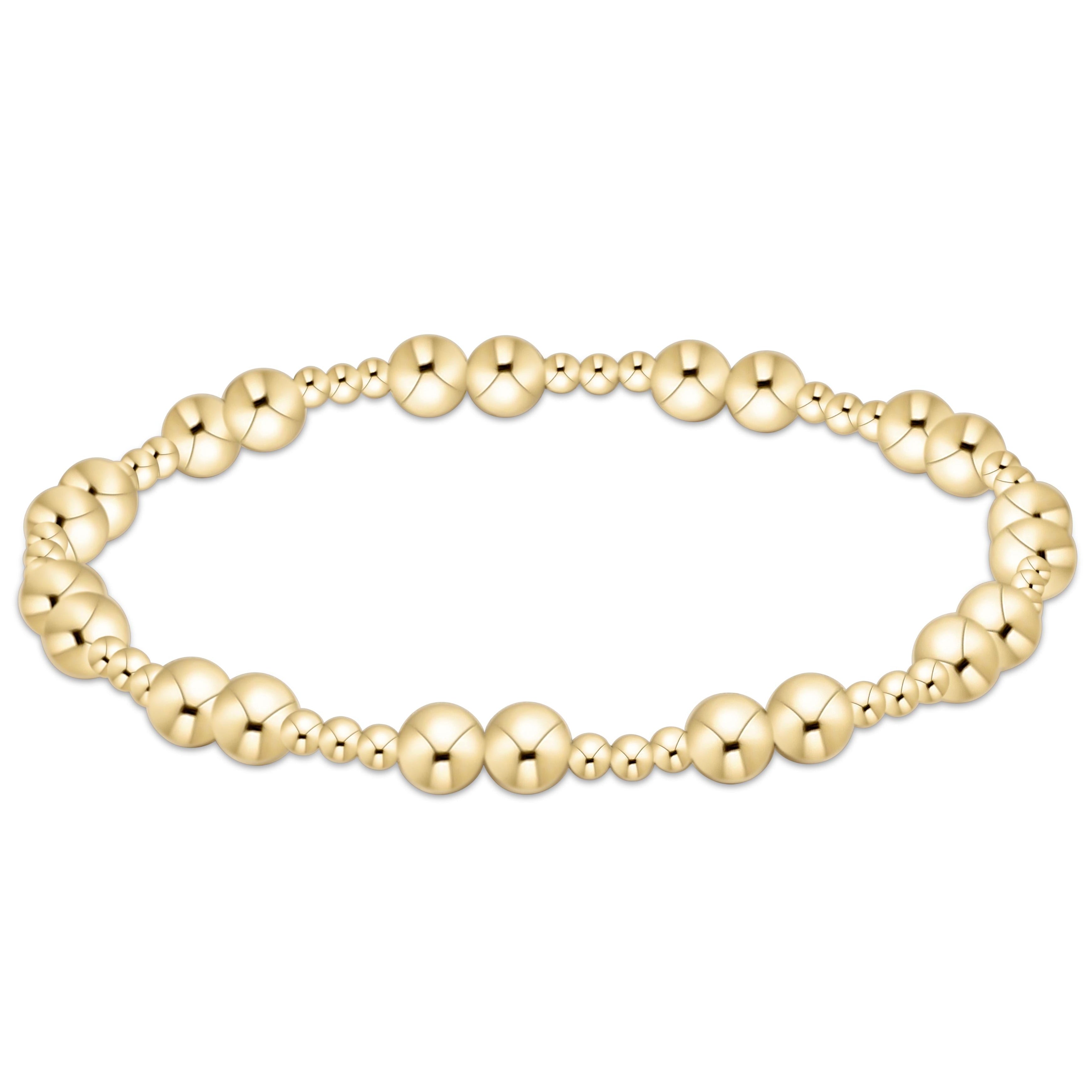 Gold beaded Together Bracelet with alternating large and small spheres on an elastic cord.