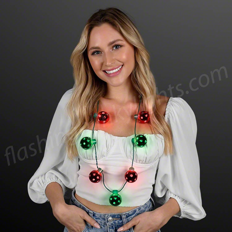 Woman wearing a Christmas Disco Light Up Party Necklace with glowing red and green disco balls.
