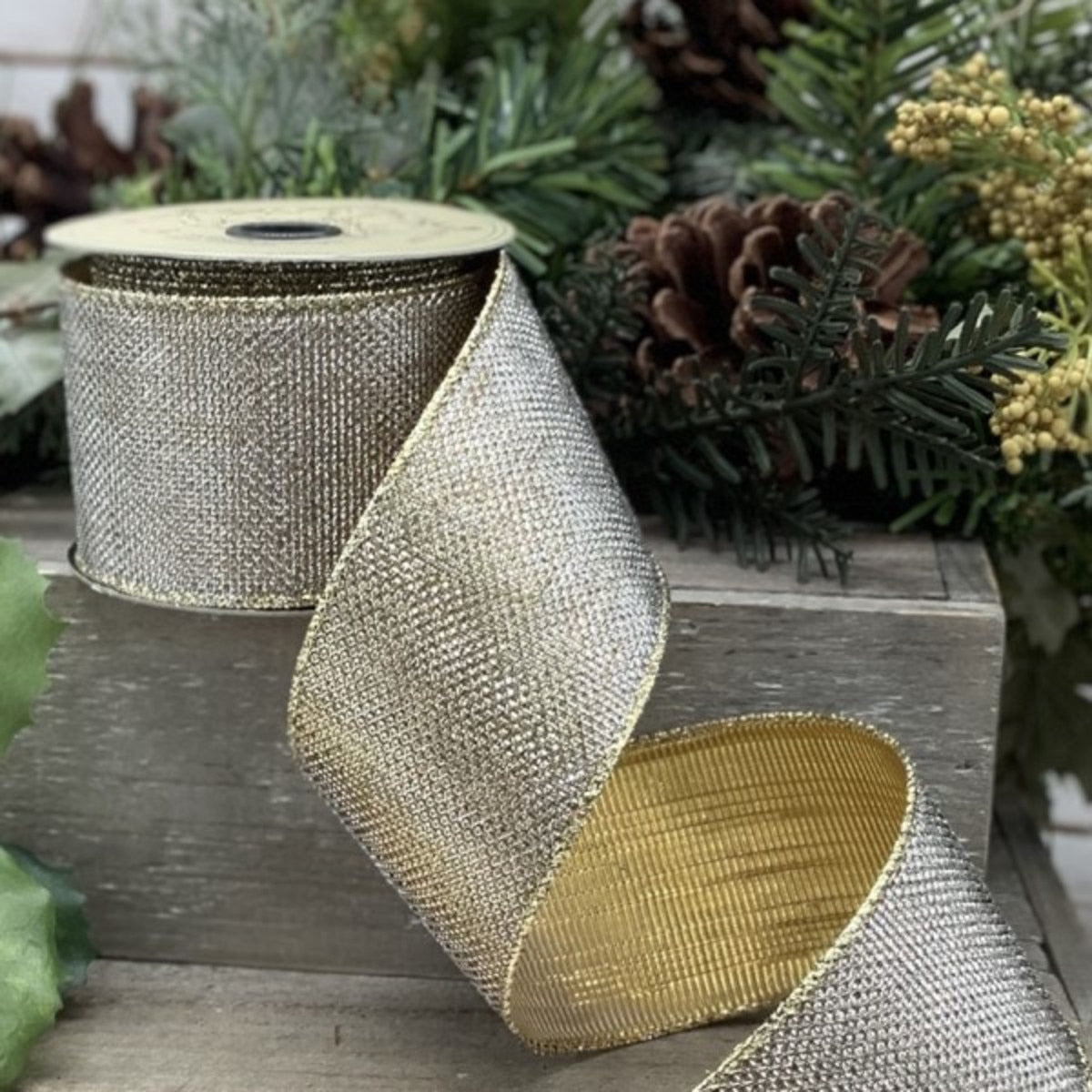A roll of gold-silver lame micro dot fabric featuring a shimmering metallic pattern.