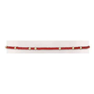 Hand-beaded Gameday Hope Unwritten bracelet featuring vibrant seed beads in red and blue with gold accents on stretch elastic.