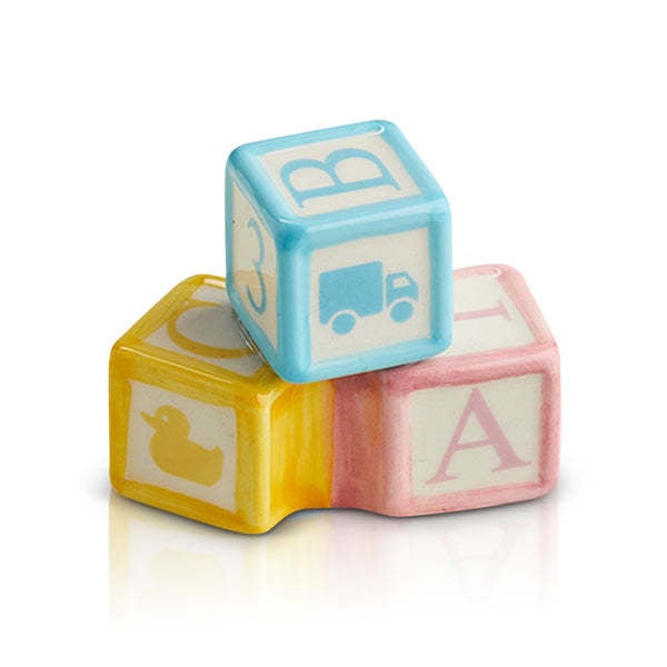 Mini Ohhh Baby plush toy in soft pastel pink with a gentle smile.
