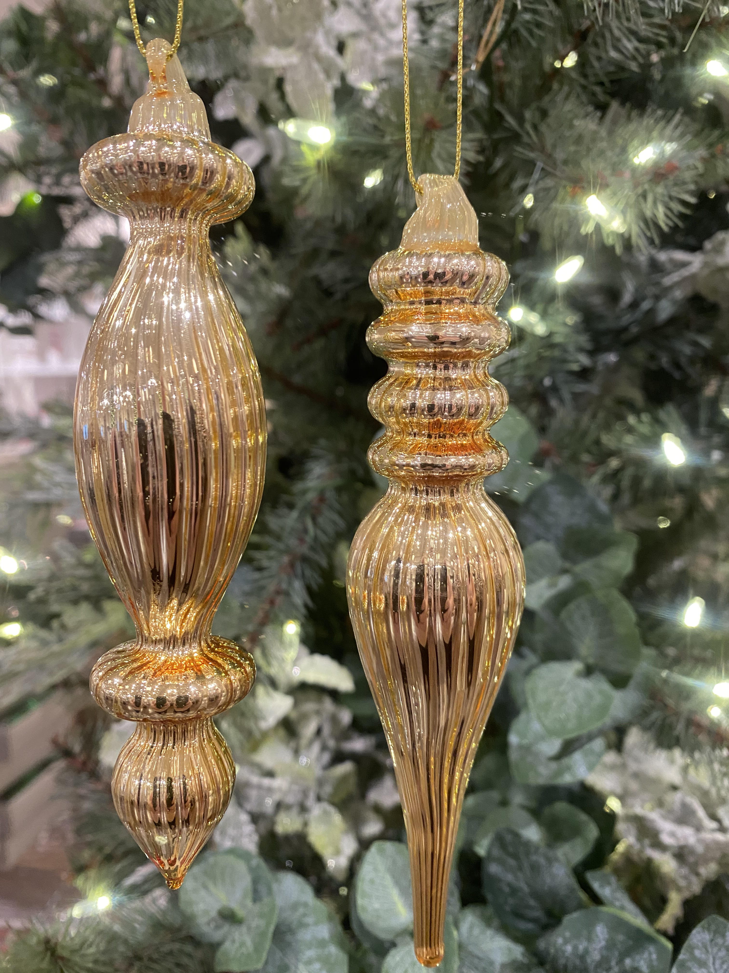 Gold metal finial ornament with a classic tapered cone shape.