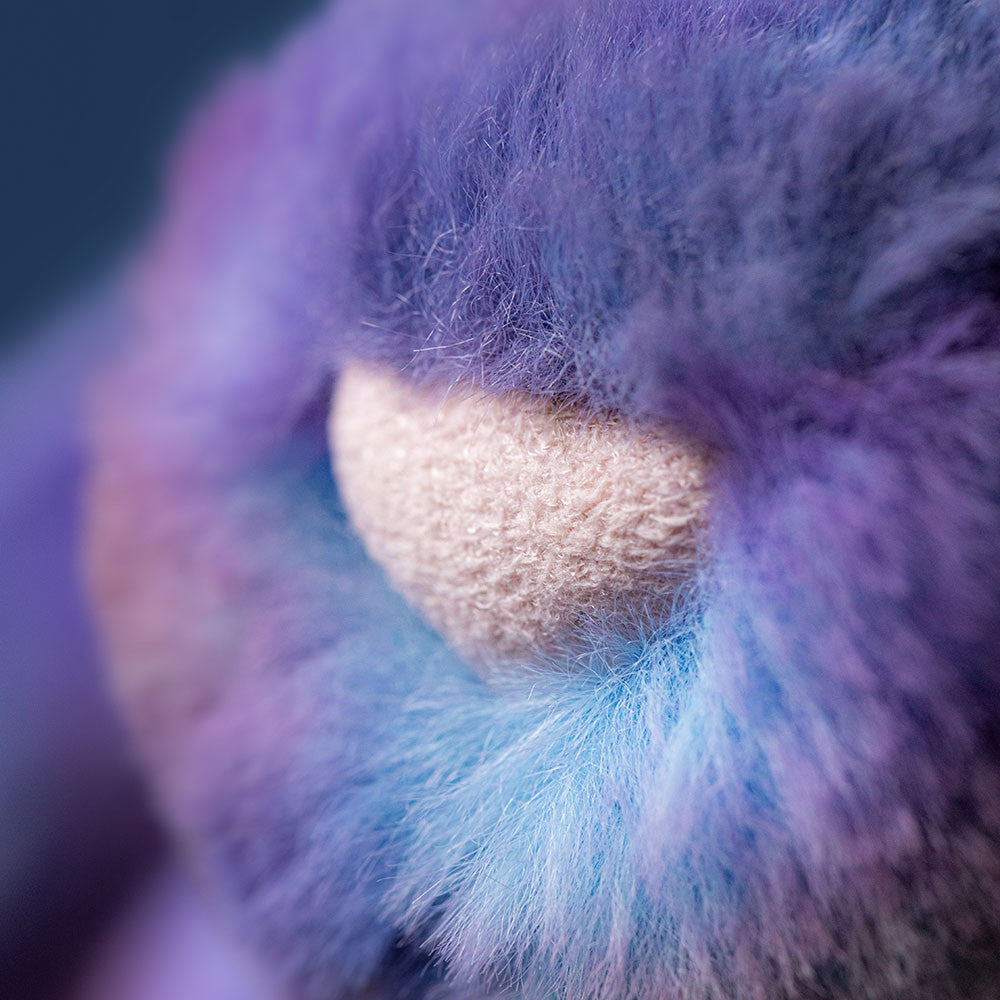 Extreme close-up of the soft purple and blue faux fur and pink nose of a Zodihop Luxe Bunny.