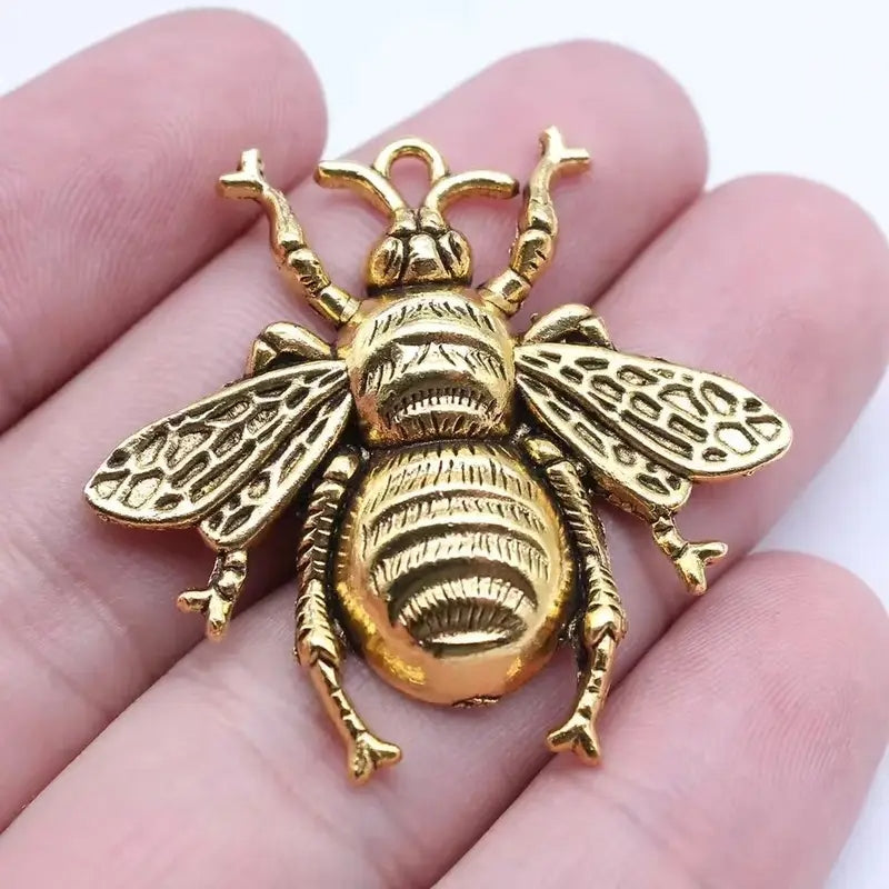 Three antique-style big queen bee pendants with a natural finish suitable for jewelry making.