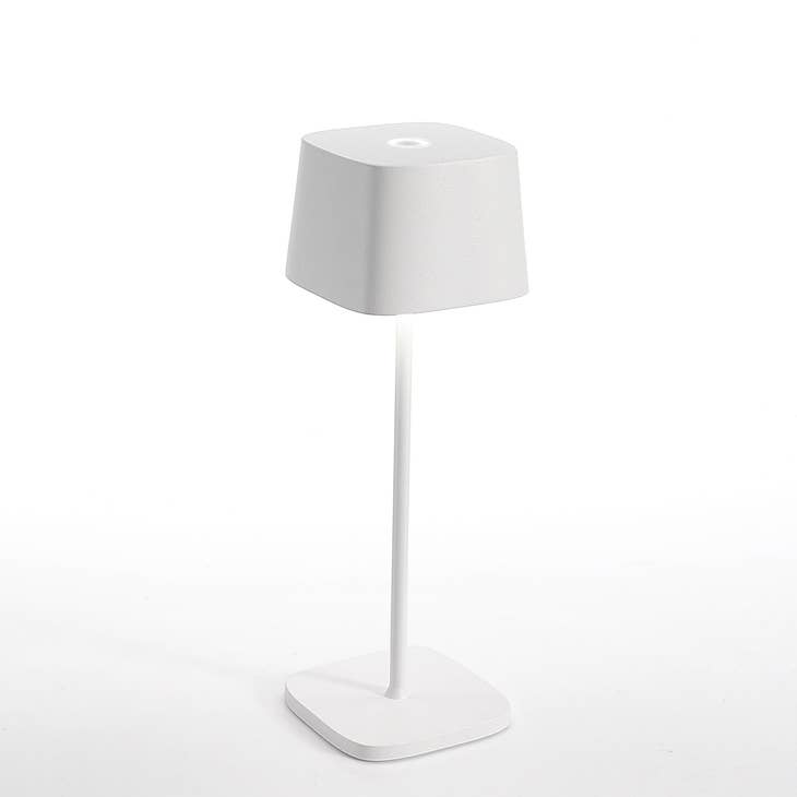 Die-cast aluminum Ofelia table lamp with translucent top in tunable white light.