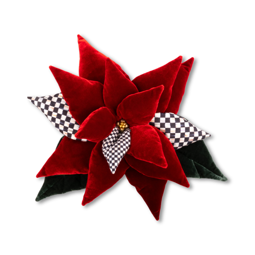 Red velvet poinsettia with checkered fabric accents and dark green leaves.