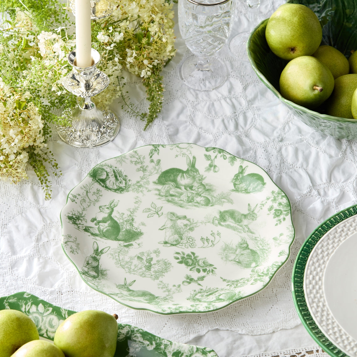 Round green platter with scalloped rim featuring French garden artwork