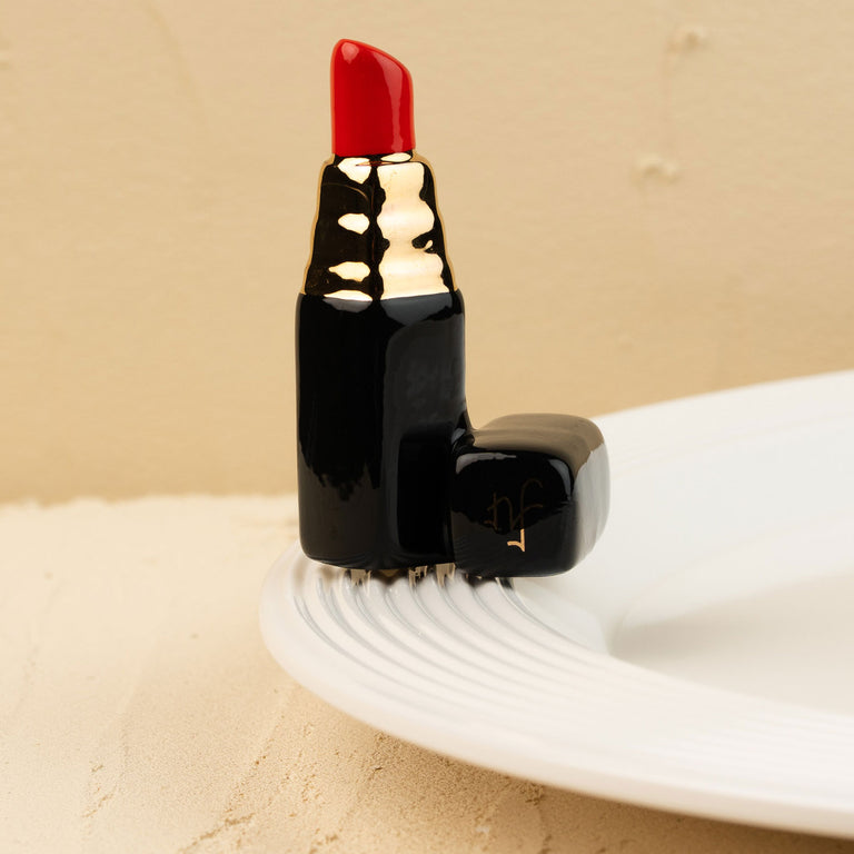 Hand-painted ceramic lipstick decorative mini with a red tip, gold accents, and a black base.