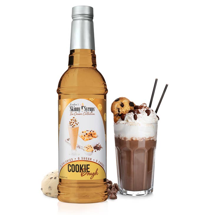 Jordan's Skinny Syrups Cookie Dough flavor bottle next to a chocolate drink with whipped cream.