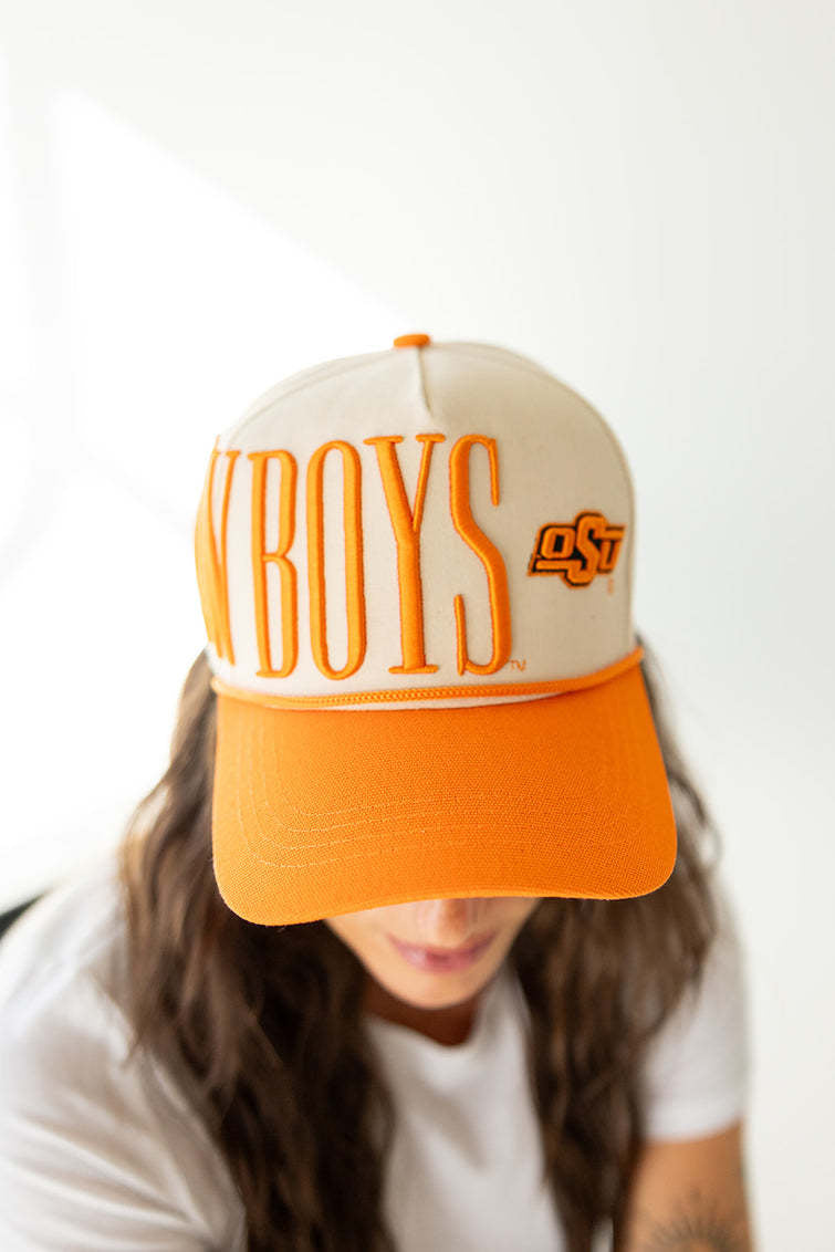Orange stretch canvas trucker hat with ivory mesh back panel.